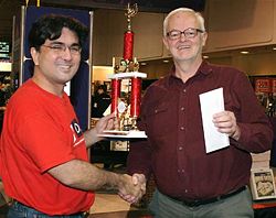 John Chew awarding the trophy to Lou Cornelis